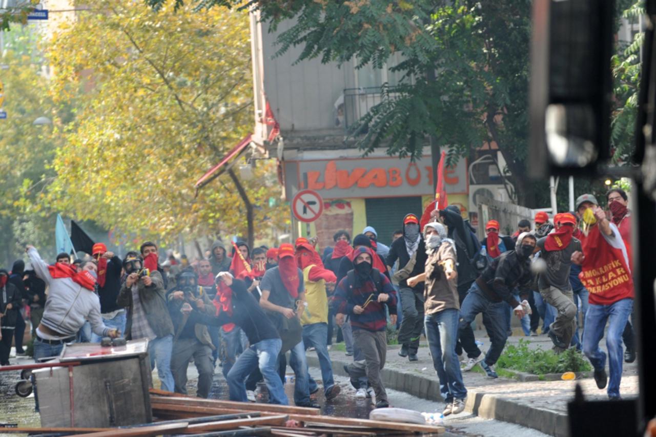 'Protesters clash with Turkish riot police during a anti-International Monetary Fund (IMF) and World Bank protest on Taksim square in Istanbul on October 6, 2009. Turkish riot police broke up the demo