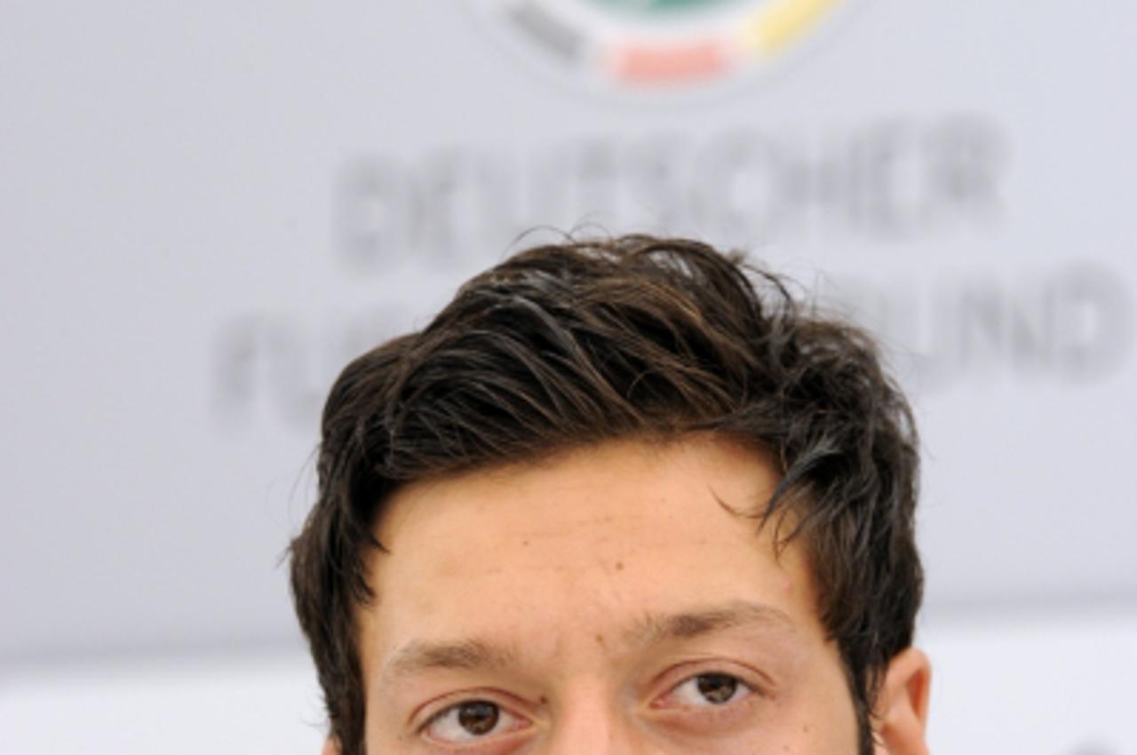 'Germany\'s midfielder Mesut Oezil addresses a press conference in Appiano, near the north Italian city of Bolzano May 25, 2010. The German football team is currently taking part in a 12-day training 