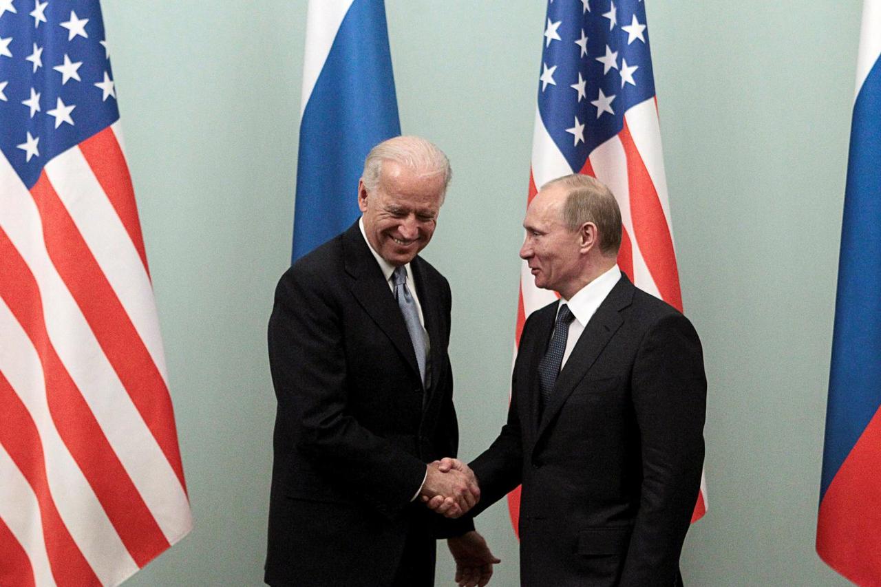 FILE PHOTO: Russian Prime Minister Putin shakes hands with U.S. Vice President Biden during their meeting in Moscow