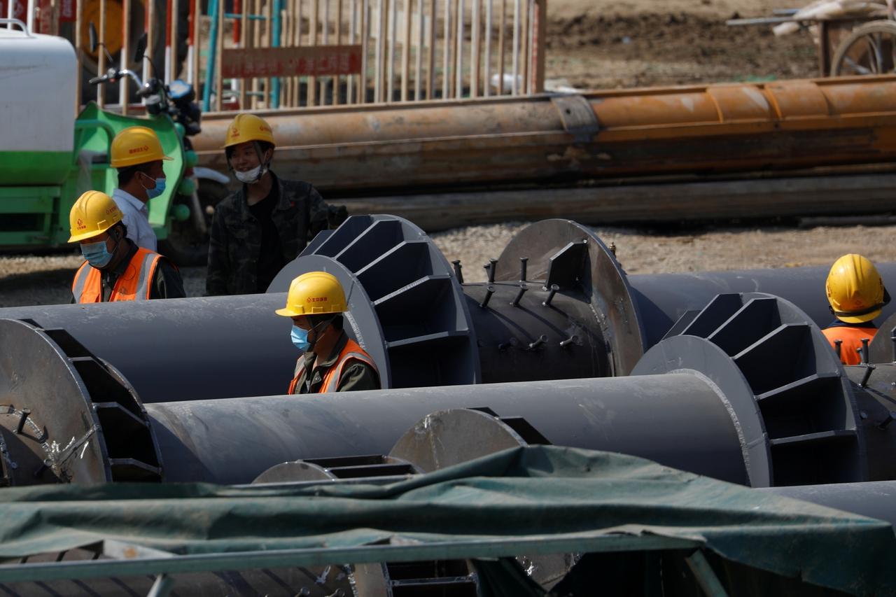 Workers wearing face masks, following the coronavirus disease (COVID-19) outbreak, work at a construction site in Beijing