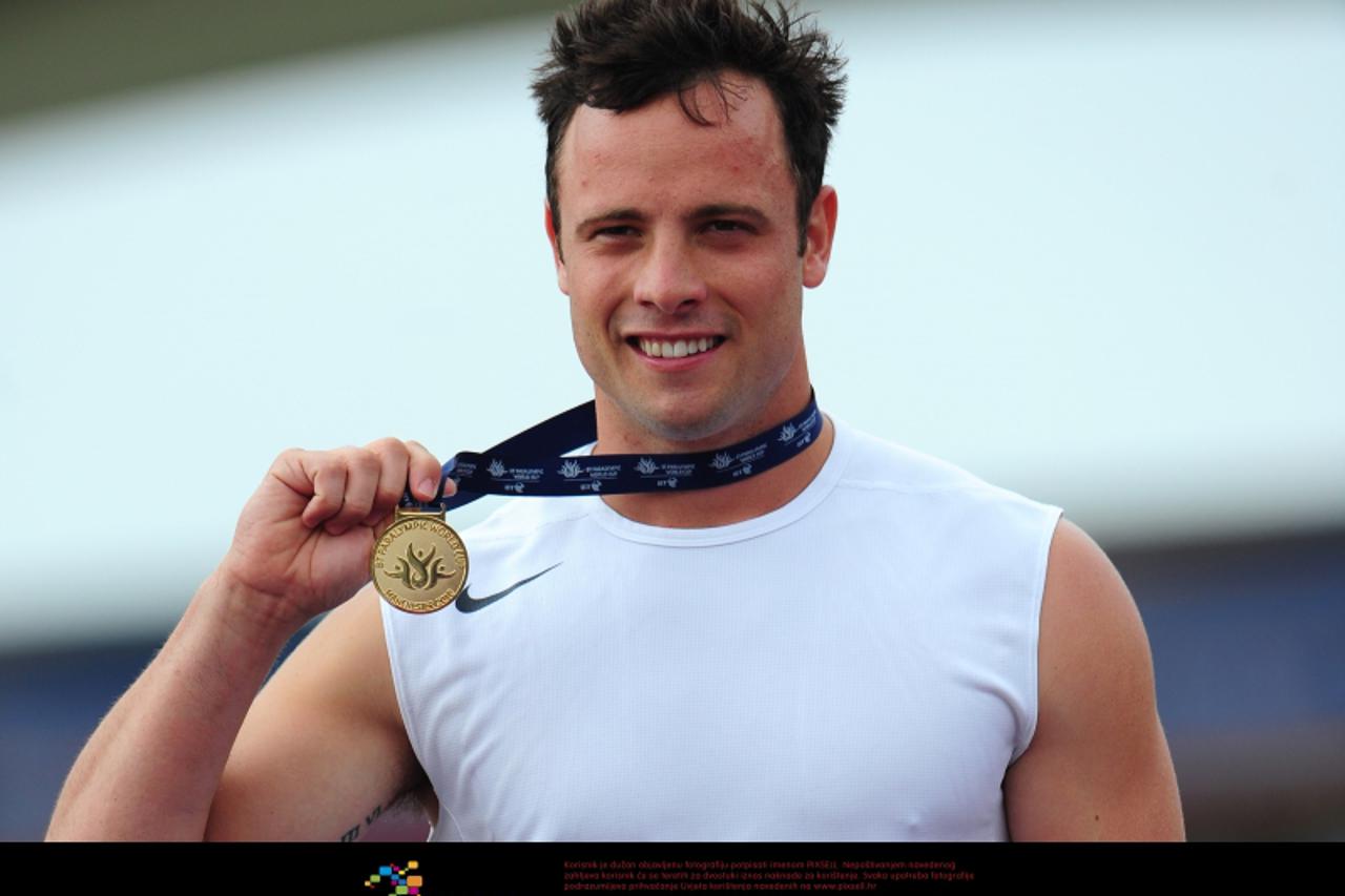 'South Africa\'s Oscar Pistorius with his gold medal from the T44 100m  Photo: Press Association/Pixsell'