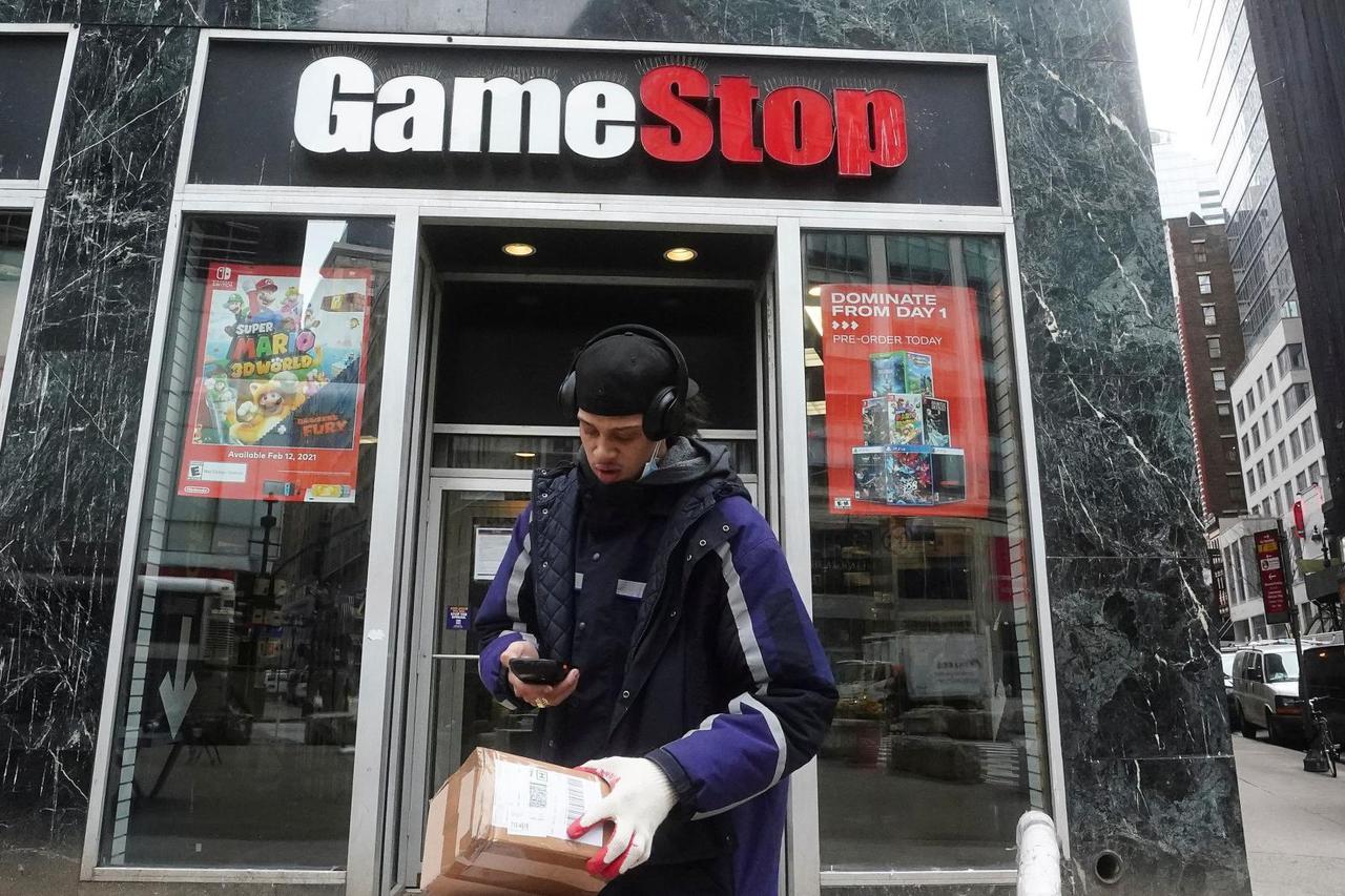 A Fedex deliveryman prepares a package for a GameStop store in New York
