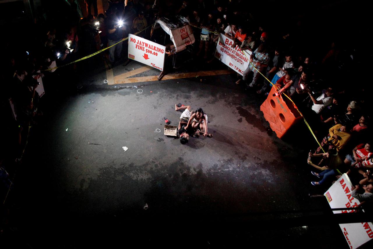 A Picture and Its Story: A death in Manila ATTENTION EDITORS - VISUAL COVERAGE OF SCENES OF INJURY OR DEATH Jennelyn Olaires, 26, weeps over the body of her partner, who was killed on a street by a vigilante group, according to police, in a spate of drug 