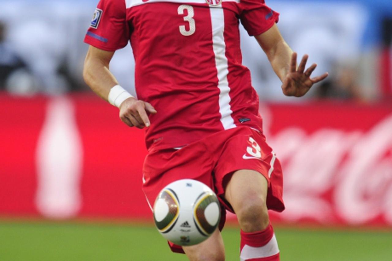 'Serbia\'s defender Aleksandar Kolarov runs with the ball during the Group D first round 2010 World Cup football match Germany vs. Serbia on June 18, 2010 at Nelson Mandela Bay stadium in Port Elizabe