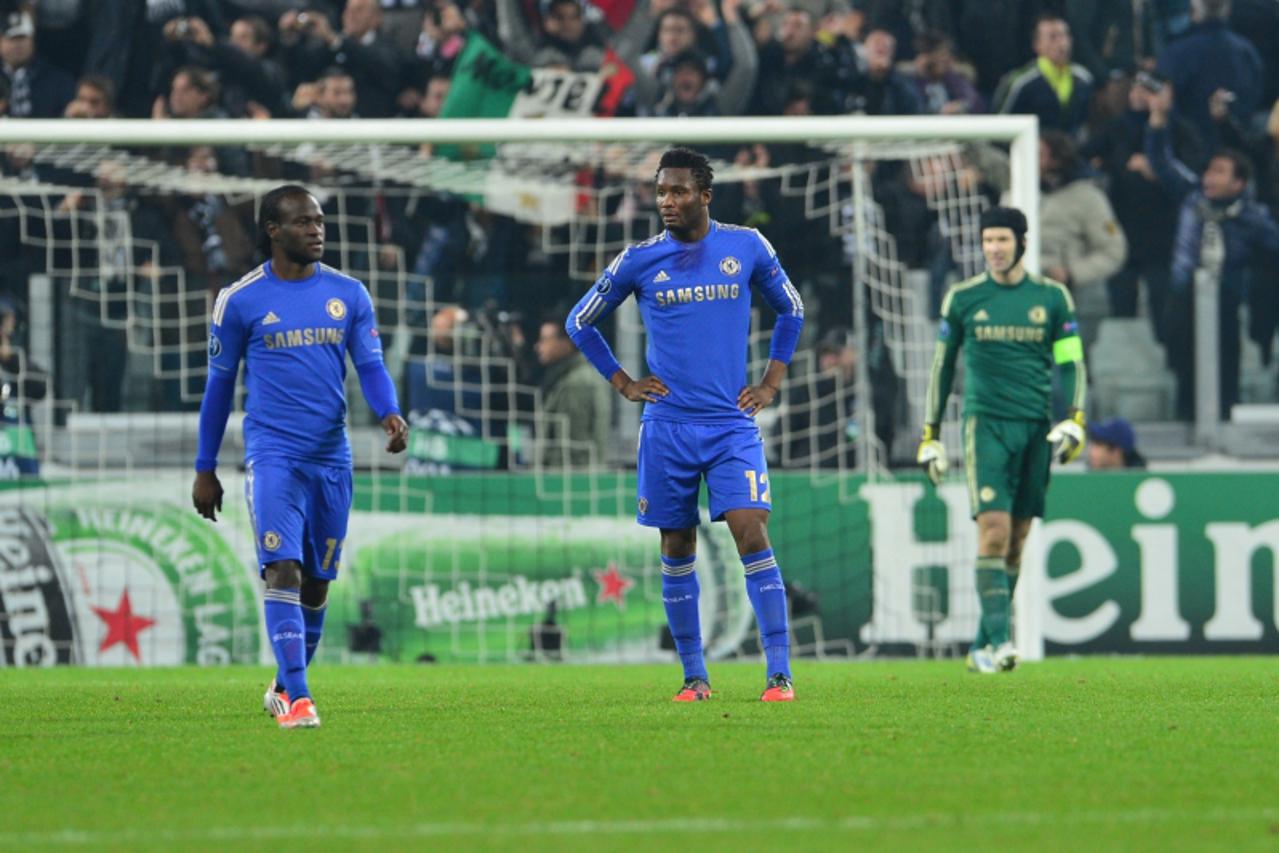 'Chelsea\'s Brazilian midfielder Ramires and Chelsea\'s Nigerian midfielder John Mikel Obi (R) reacts after Juventus\' midfielder of Chile Arturo Vidal scored during the Champions League football matc
