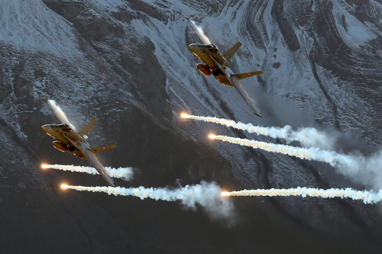 FILE PHOTO: Swiss Air Force F/A18 Hornet fighter jets release flares over the Axalp