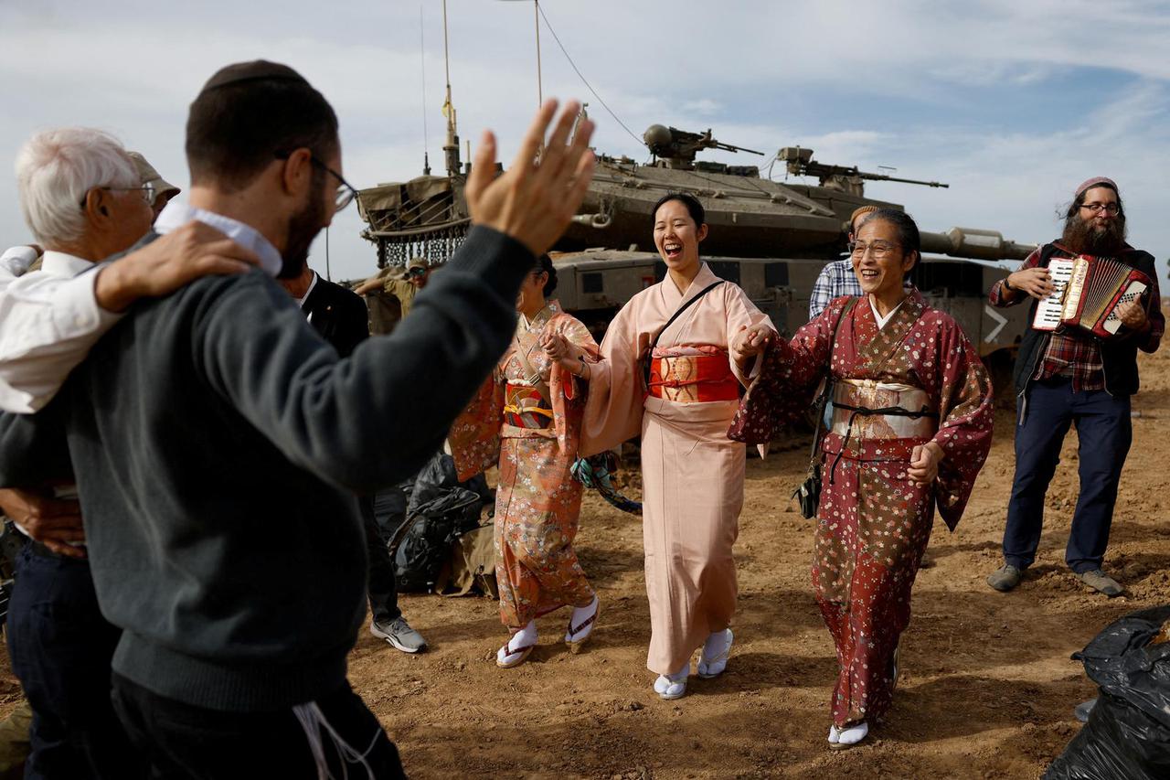 Japanese supporters of Israel dance with Israeli soldiers