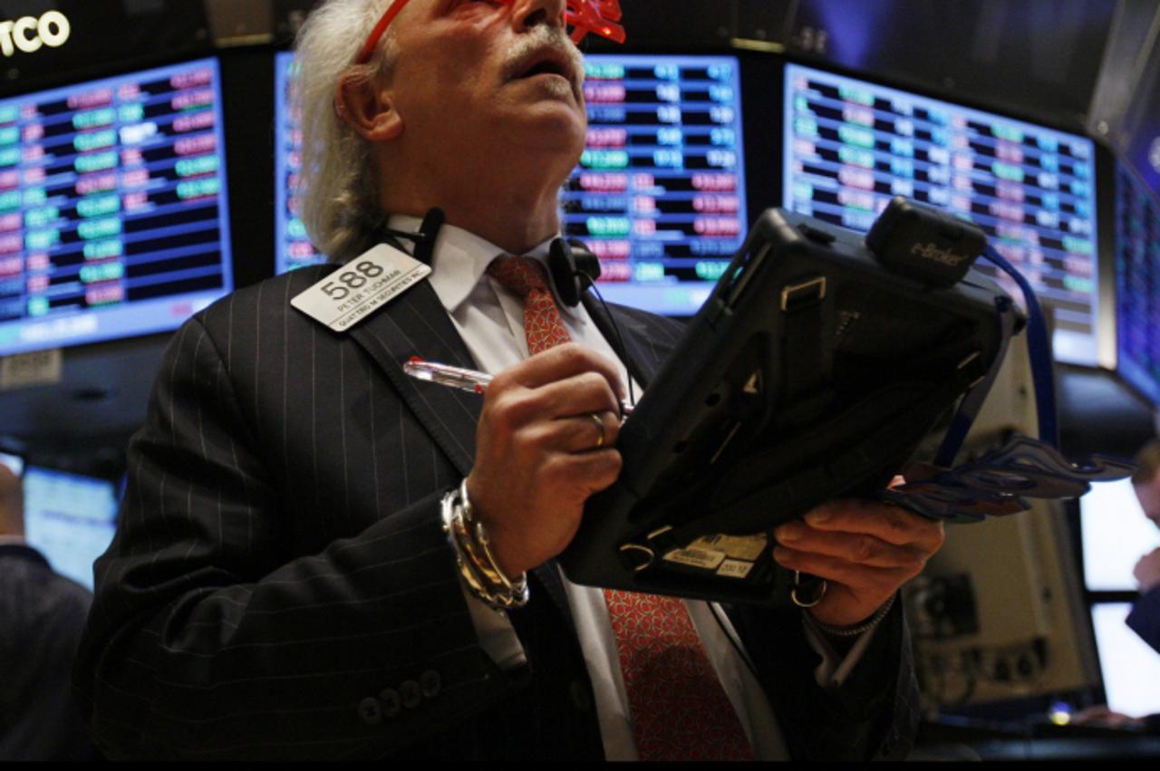 'WORLD RIGHTS NO USA, FRANCE, AUSTRALIA. Traders wear 2012 glasses on the floor of the New York Stock Exchange moments before the opening bell on the last day of trading in 2011 at the NYSE on Wall St