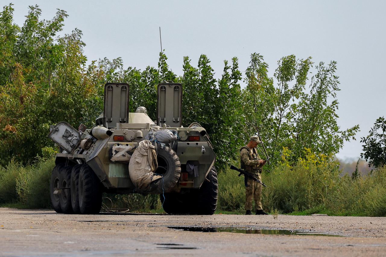 A Russian service member stands guard in Enerhodar