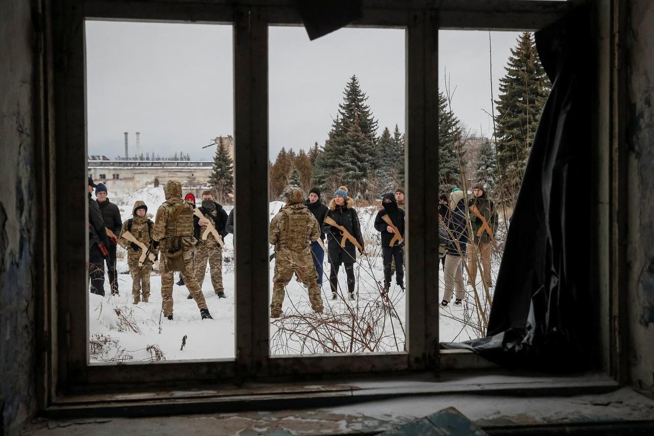 People take part in a military exercise for civilians conducted by veterans of the Ukrainian National Guard Azov battalion in Kyiv