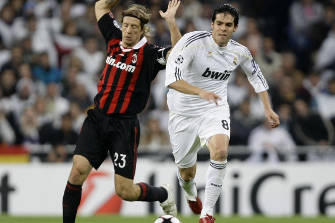 'Real Madrid\'s Kaka (R) is challenged by AC Milan\'s Massimo Ambrosini during their Champions League soccer match at the Santiago Bernabeu stadium in Madrid, October 21, 2009. REUTERS/Sergio Perez (S