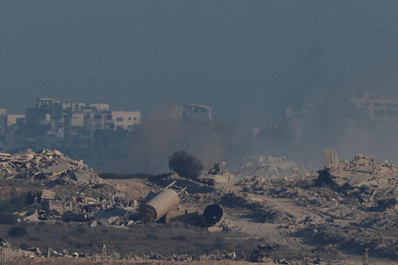 An Israeli armoured personnel carrier (APC) manoeuvres in Gaza, as seen from the Israeli side of the border