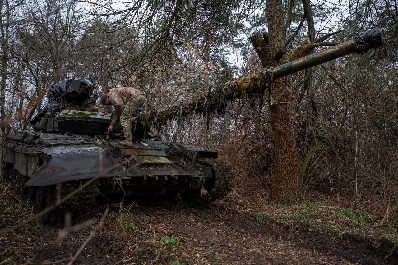 Ukrainian serviceman is seen on a tank at a position in an undisclosed location in Ukraine