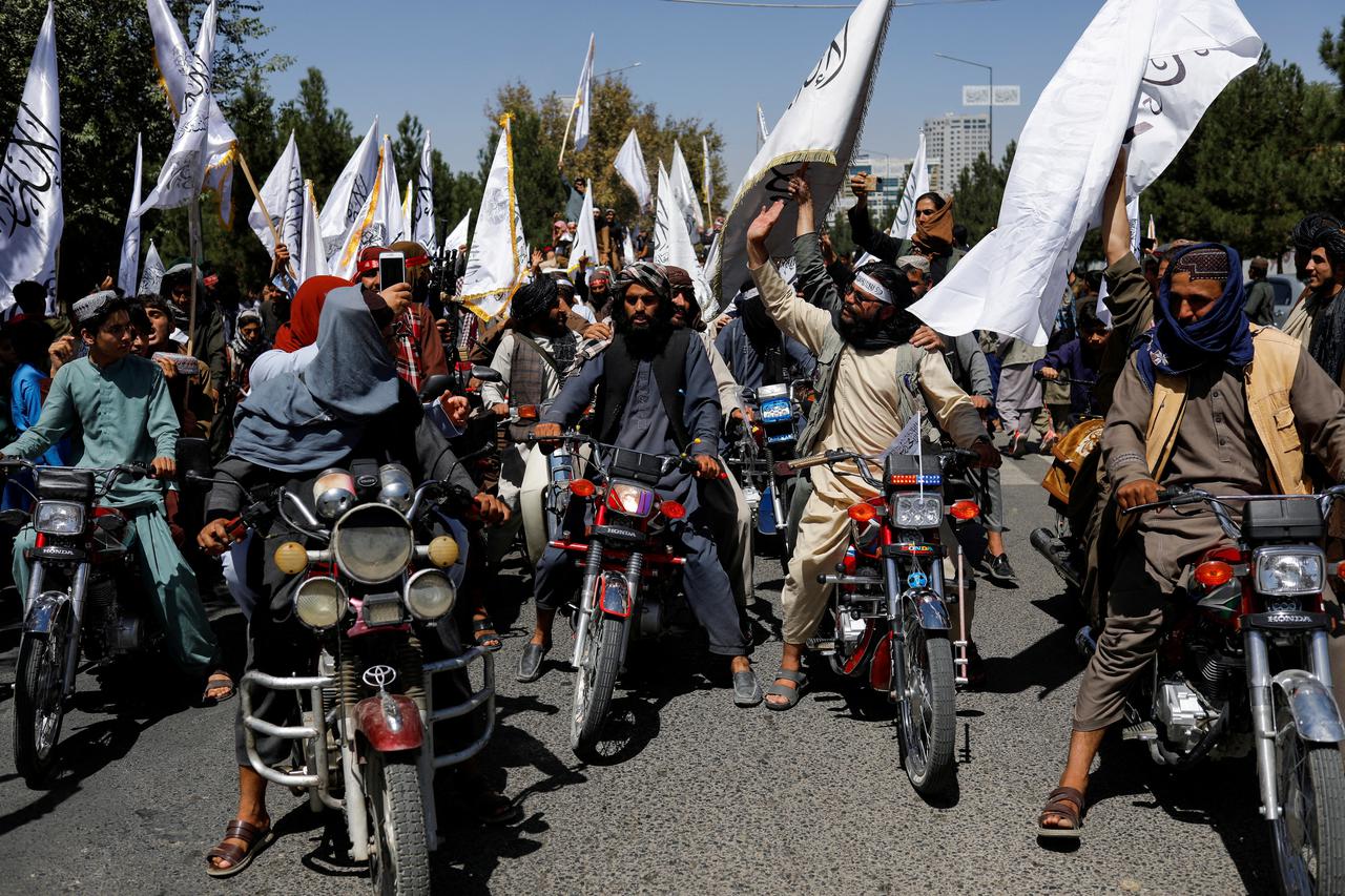 FILE PHOTO: FILE PHOTO: Taliban members celebrate on the second anniversary of the fall of Kabul on a street near the US embassy in Kabul