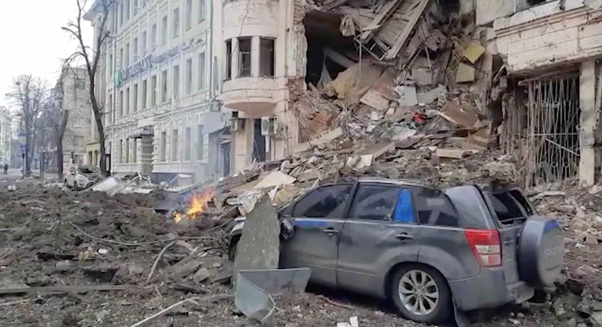 View of a crushed car amid the rubble as fire crews (not pictured) work after further attacks during Russia's invasion of Ukraine, in Kharkiv, March 14, 2022 in this still image from handout video. Courtesy of State Emergency Service of Ukraine/Handout via REUTERS THIS IMAGE HAS BEEN SUPPLIED BY A THIRD PARTY.