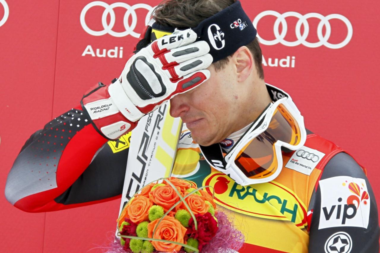 'Ivica Kostelic of Croatia reacts in pain during the podium ceremony for the men\'s Alpine Skiing World Cup Super Combined event in Rosa Khutor near Sochi February 12, 2012. Kostelic injured his knee 
