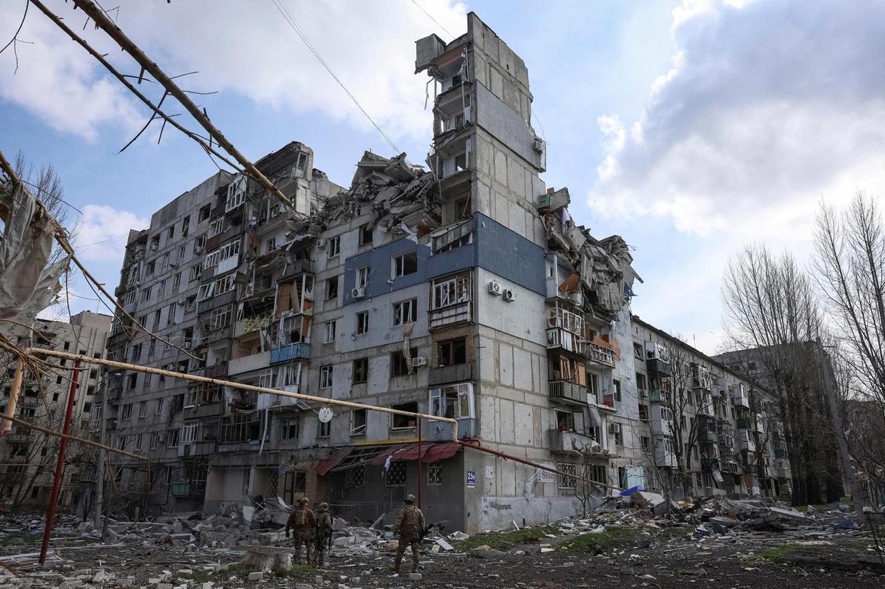 FILE PHOTO: Ukrainian police officers try to persuade residents to evacuate in the frontline town of Pokrovsk