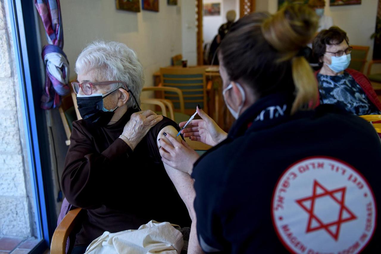 A Health Worker Holds Empty Vials Of Pfizer BioNTech COVID Vaccine In The Migdal Nofim Assisted Living Facility In Jerusalem
