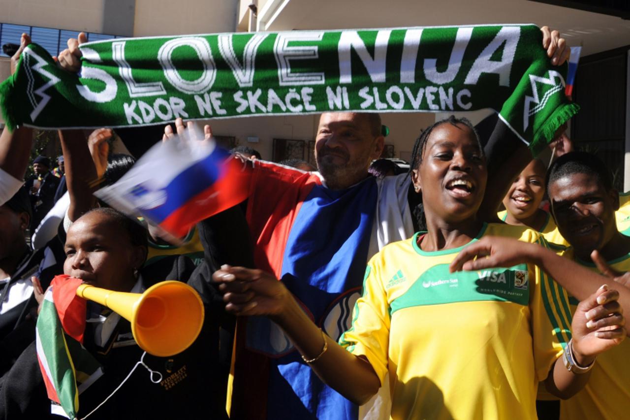 'A Slovenian fan dances among South African volunteers on the arrival of Slovenia\'s national football team at the hotel in Johannesburg on June 7, 2010 ahead of the start of the South Africa 2010 Wor