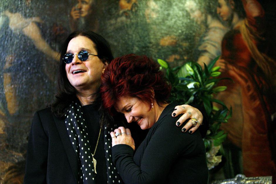 FILE PHOTO: Ozzy and Sharon Osbourne smile pose in front of their belongings in Beverly Hills