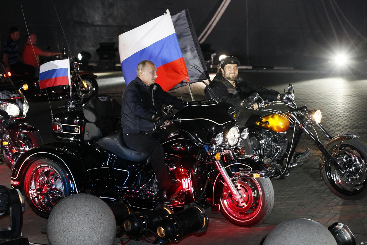 Russian Prime Minister Vladimir Putin (C) rides with Alexander Zaldostanov, leader of Nochniye Volki (the Night Wolves) biker group, during his visit to a bike festival in the southern Russian city of Novorossiisk August 29, 2011. REUTERS/Ivan Sekretarev/