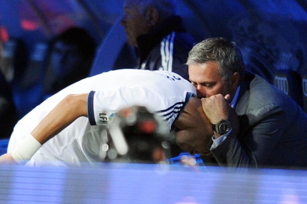 'Real Madrid\'s Portuguese defender Pepe (L) is congratulated by Real Madrid\'s Portuguese coach Jose Mourinho (R) after scoring during the Spanish league football match Real Madrid against Deportivo 