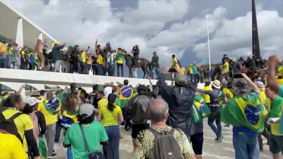 Members of the security forces on horseback attempt to disperse supporters of Brazil's former President Jair Bolsonaro during a demonstration against President Luiz Inacio Lula da Silva, in Brasilia