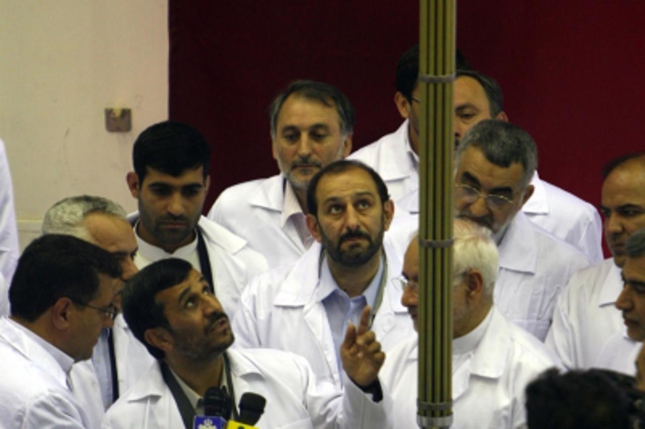 'TO GO WITH AFP STORY BY JAY DESHMUKH  (FILES) -- File picture dated April 9, 2009 shows Iranian President Mahmoud Ahmadinejad unveiling domestically manufactured fuel rods at a fuel manufacturing pla