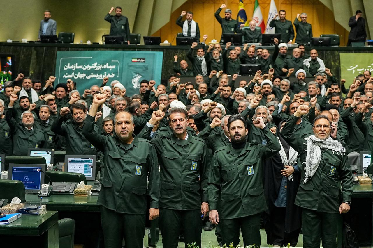 Iranian parliament members chant in support of the IRGC while wearing military uniforms in Tehran