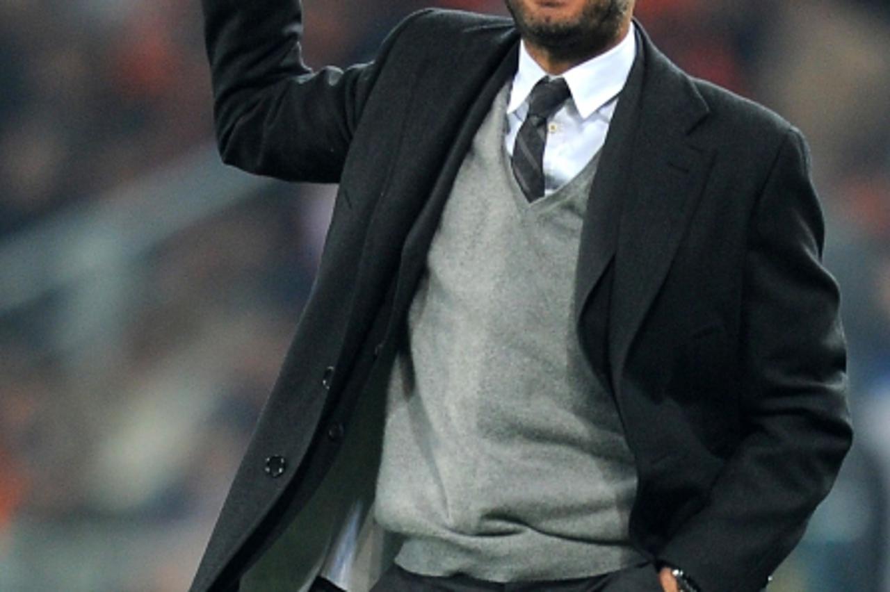 'Barcelona\'s coach Pep Guardiola gestures during the Champions League quarter-final second leg fotball match Shakhtar Donetsk against FC Barcelona at Donbass Arena in Donetsk, on April 12, 2011. AFP 