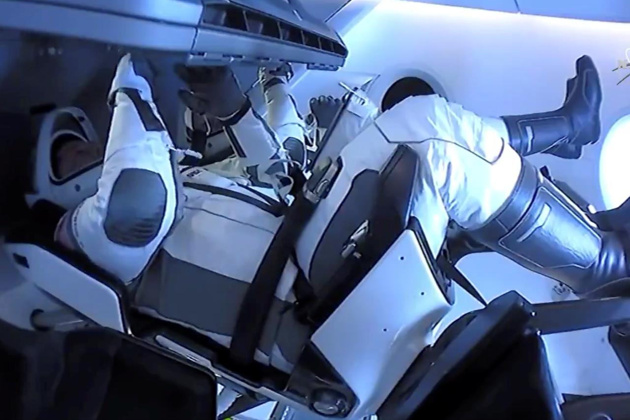 NASA astronauts Robert Behnken and Douglas Hurley are seen aboard SpaceX's Dragon Endeavour spacecraft