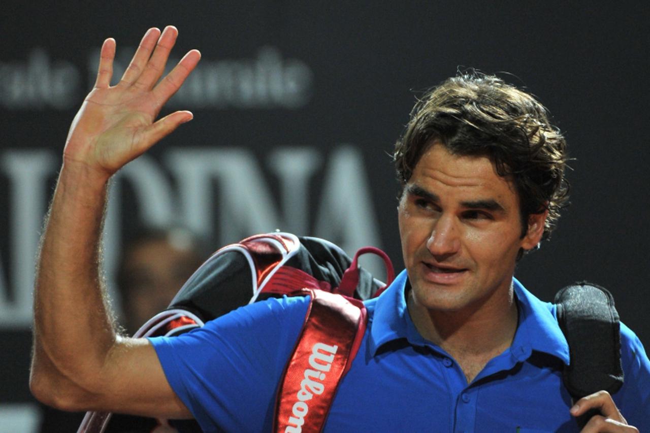 'Swiss Roger Federer reacts at the end of his semi-finals match against Serbia\'s Novak Djokovic at the ATP Rome tournament on May 19, 2012 in Rome. Djokovic defeated Federer  6-2, 7-6 (7/4).   AFP PH