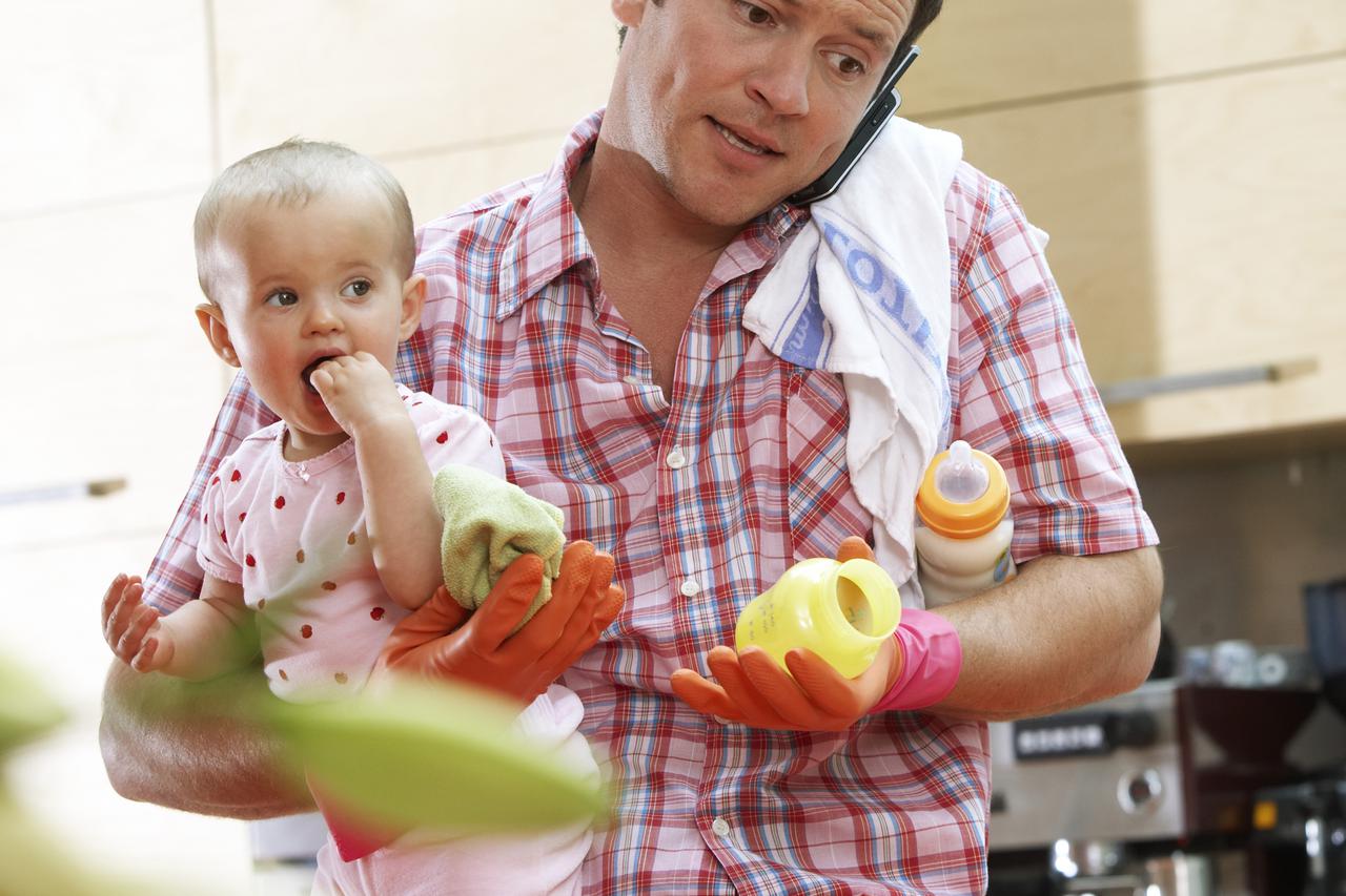 Househusband with Baby Multi-Tasking