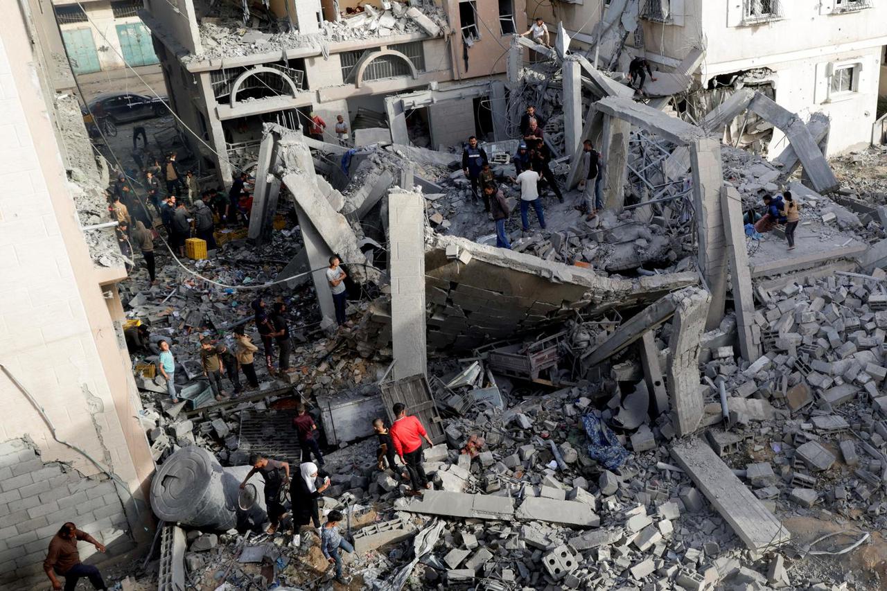 Palestinians gather at the site of an Israeli strike on a house, in Khan Younis