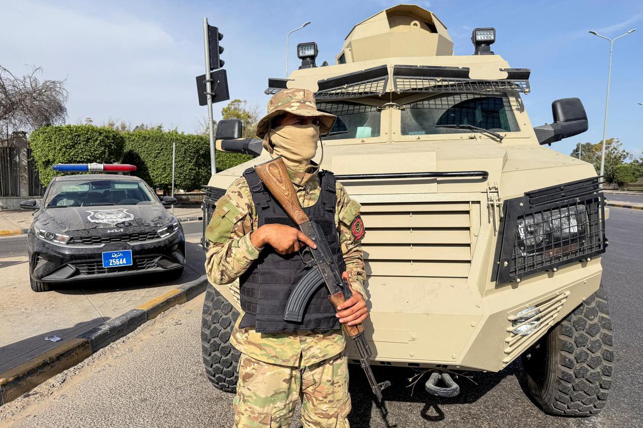 Members of the 444 Brigade of the Libyan Army stand guard at Abu Salim area in Tripoli