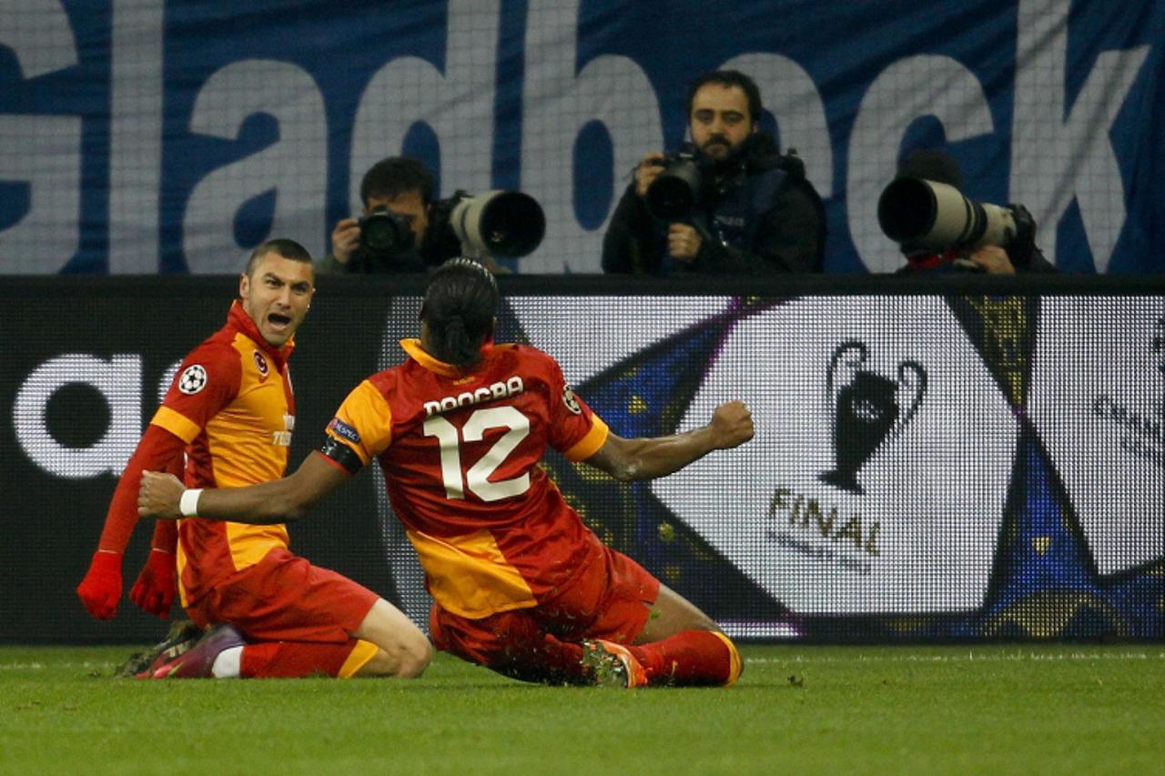 'Galatasaray\'s Burak Yilmaz (L) and Didier Drogba celebrate a goal against Schalke 04 during the Champions League soccer match in Gelsenkirchen March 12, 2013. REUTERS/Ina Fassbender  (GERMANY - Tags