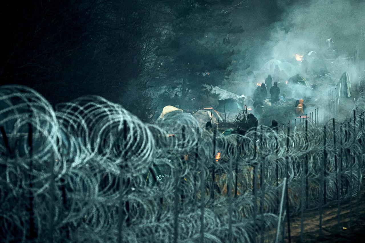 Migrants are seen on the Belarus side of the border with Poland near Kuznica