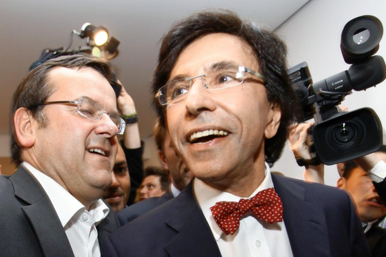 \'PS Chairman Elio Di Rupo (C) arrives with Willy Demeyer (L) at the French-speaking socialist party PS elections meeting as part of the general elections, on June 13 2010 in Brussels. In Wallonia, PS