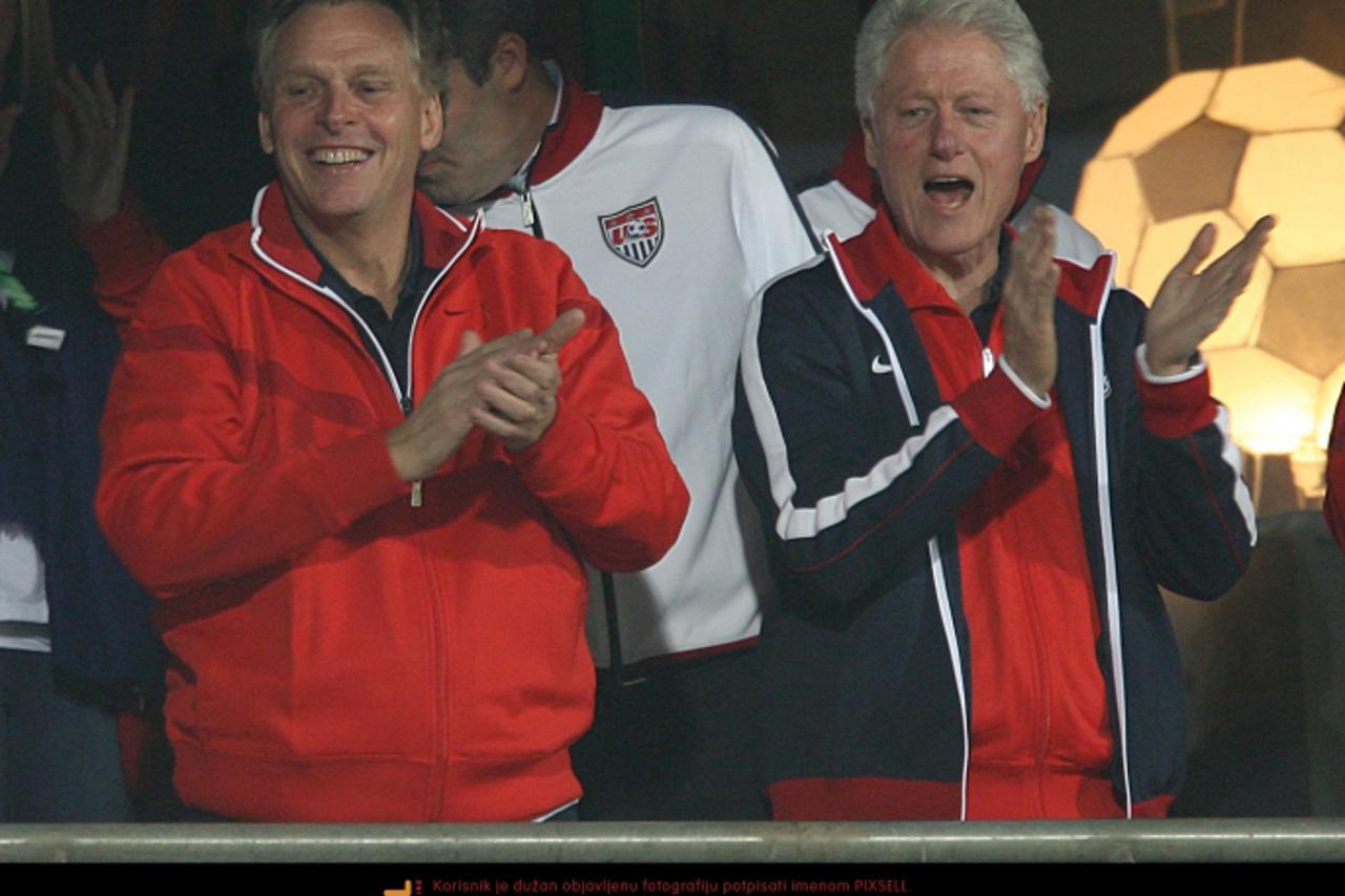 'Former U.S President Bill Clinton (right) cheering in the stands. Photo: Press Association/Pixsell'