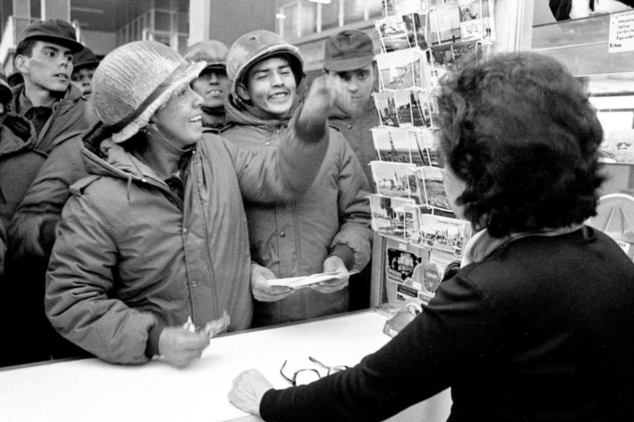\'Argentine soldiers buy postcards at a souvenir shop in Stanley, 13 April 1982. Twenty-five years after the Falklands / Malvinas war, Argentina continues to claim sovereignty over the islands, which 