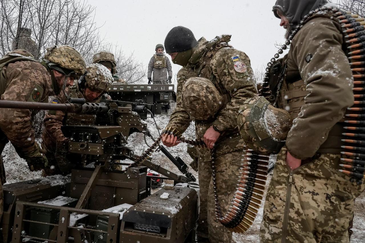 Ukrainian servicemen test an unmanned ground vehicle with Browning M2 machine gun installed on it, in Kharkiv region
