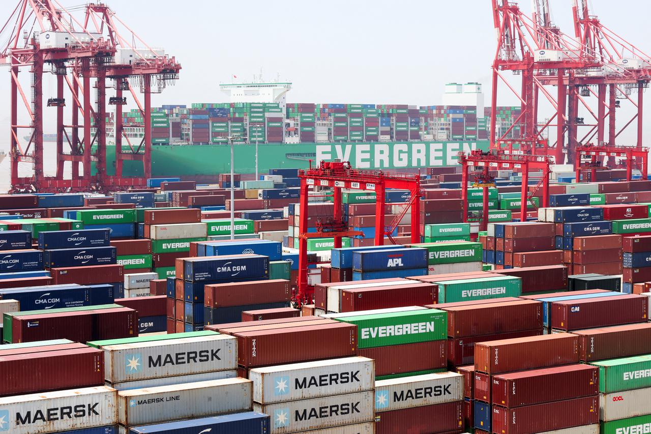 Gantry cranes stand near shipping containers as an Evergreen Marine Corp container ship, Ever Ace, is docked at Yangshan Port outside of Shanghai