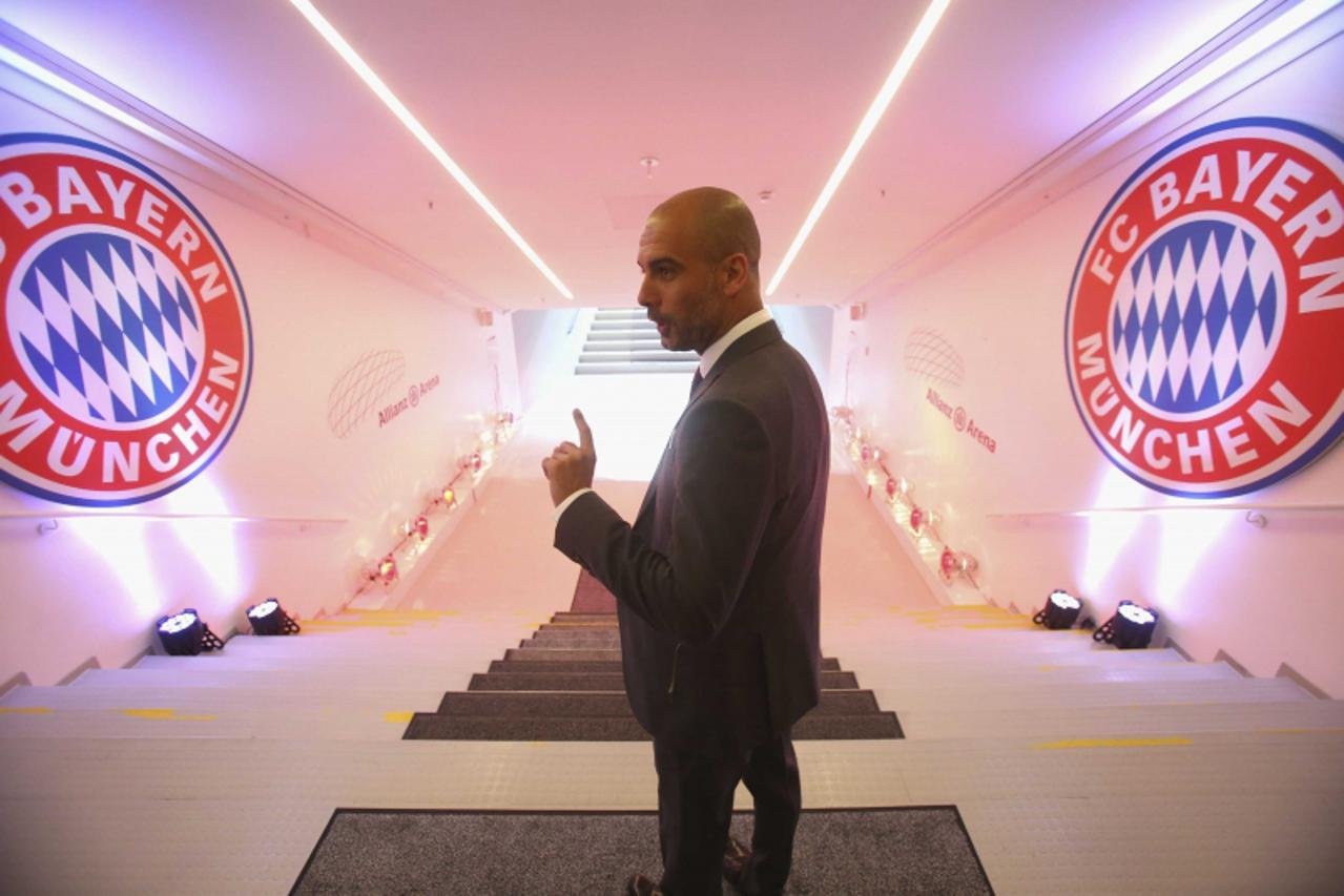 'Bayern Munich new head coach Pep Guardiola walks through the players tunnel and up the stairs to the pitch inside the Allianz Arena in Munich June 24, 2013. Treble-winning Bayern Munich unveiled thei