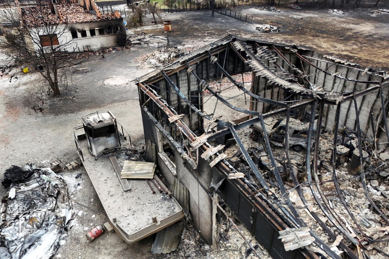 A drone view shows burnt building in an area affected by wildfire, in Le Porge