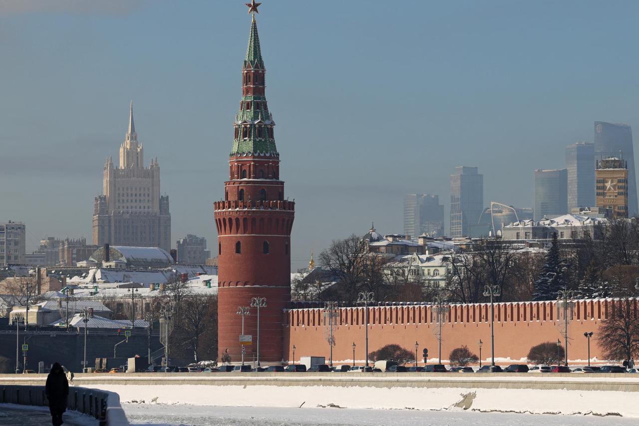 A person walks along an embankment of the Moskva River in Moscow