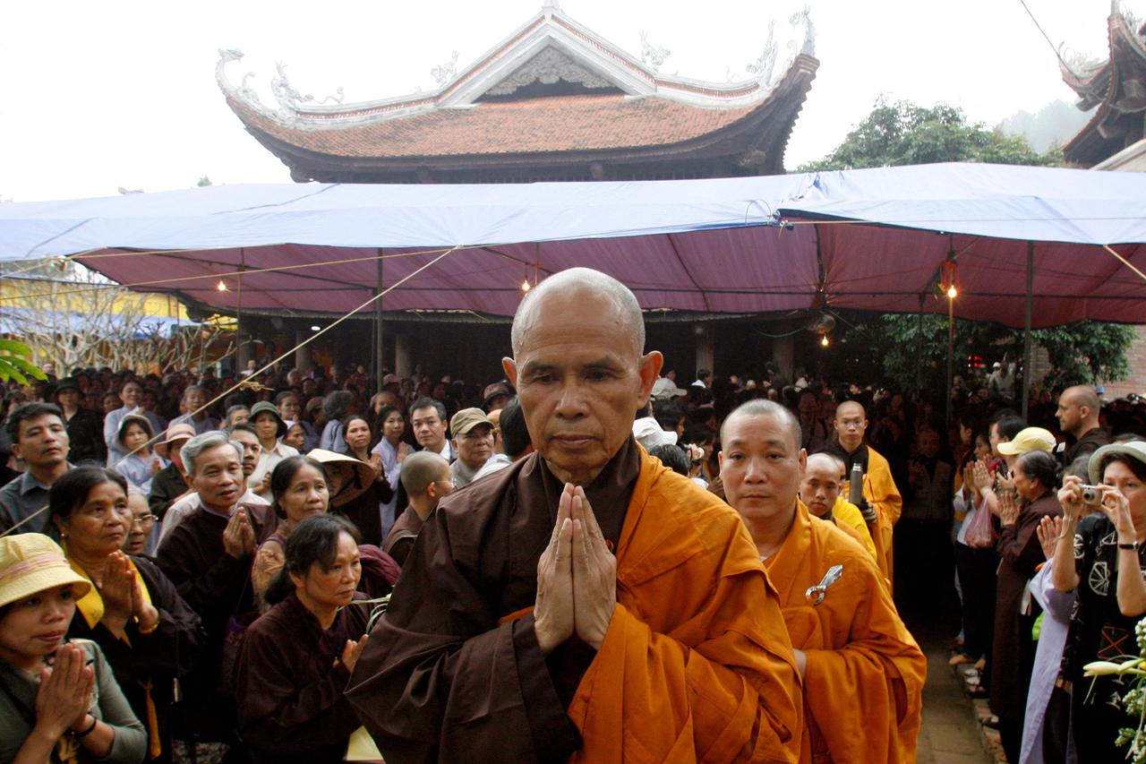 FILE PHOTO: Buddhist monk Nhat Hanh walks among believers at a requiem mass at the Non Nuoc pagoda outside Hanoi