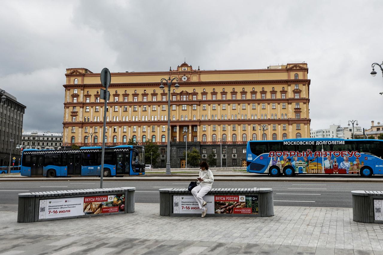 FILE PHOTO: A woman uses her mobile phone in front of the Federal Security Service in Moscow