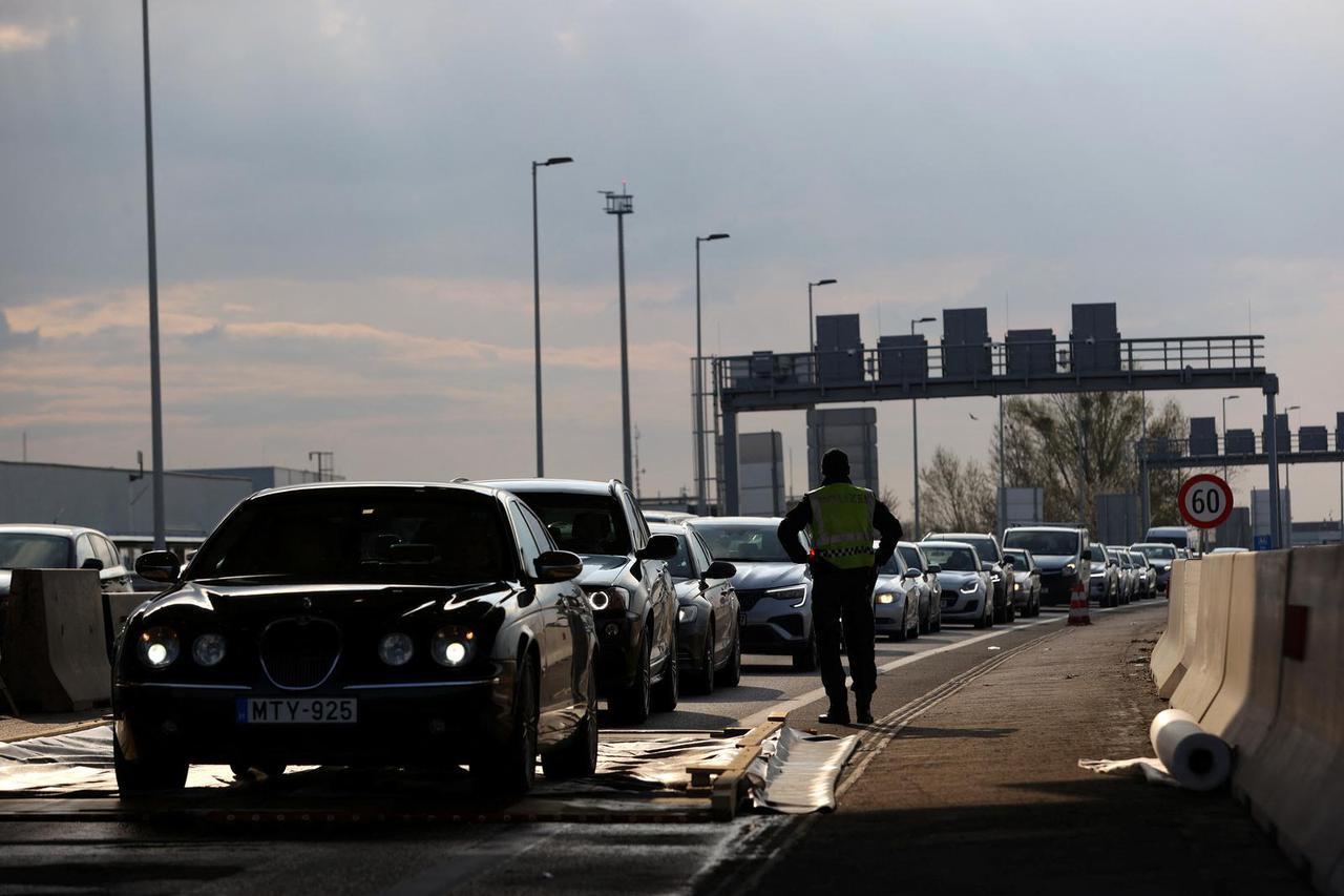 Cars drive through a disinfectant mat during the outbreak of foot-and-mouth disease at the Austrian-Hungarian border