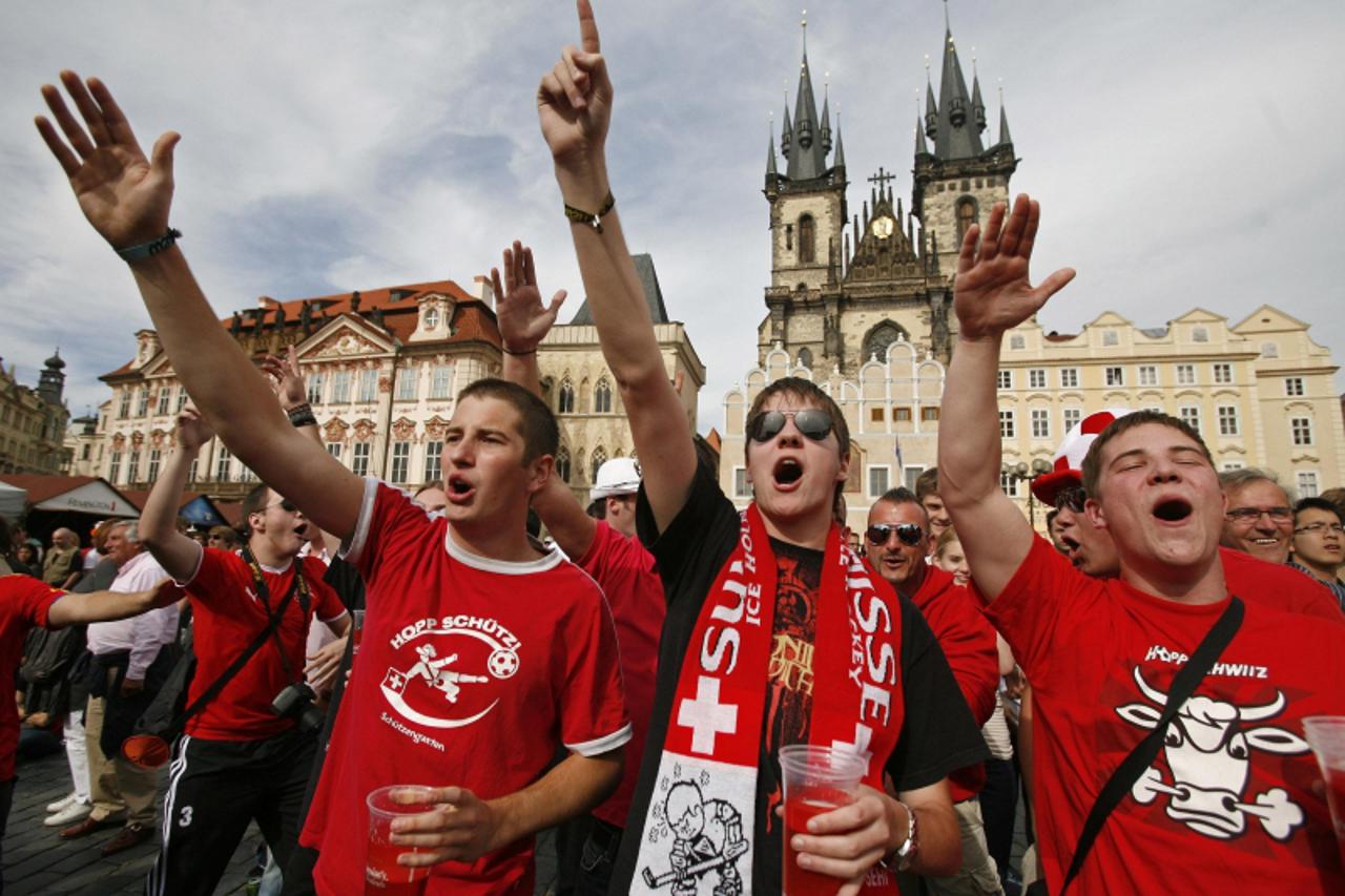 \'Swiss fans celebrate at the end of the 2010 World Cup soccer match between Spain and Switzerland at the Old Town square in Prague June 16, 2010.    REUTERS/David W Cerny (CZECH REPUBLIC - Tags: SPOR