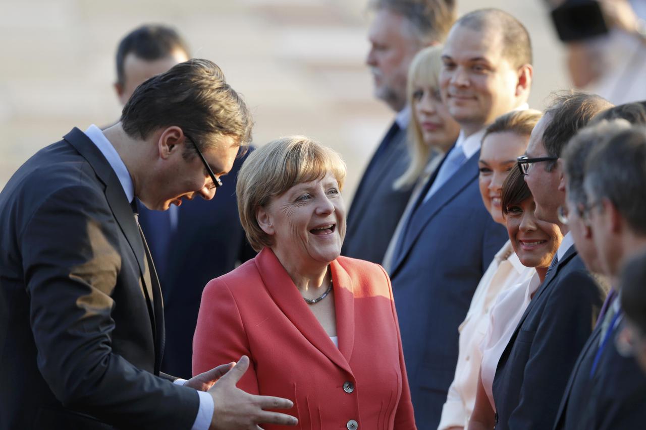 German Chancellor Angela Merkel meets local officials next to Serbia's Prime Minister Alexandar Vucic (L) as she arrives in Belgrade, Serbia July 8, 2015. REUTERS/Marko Djurica